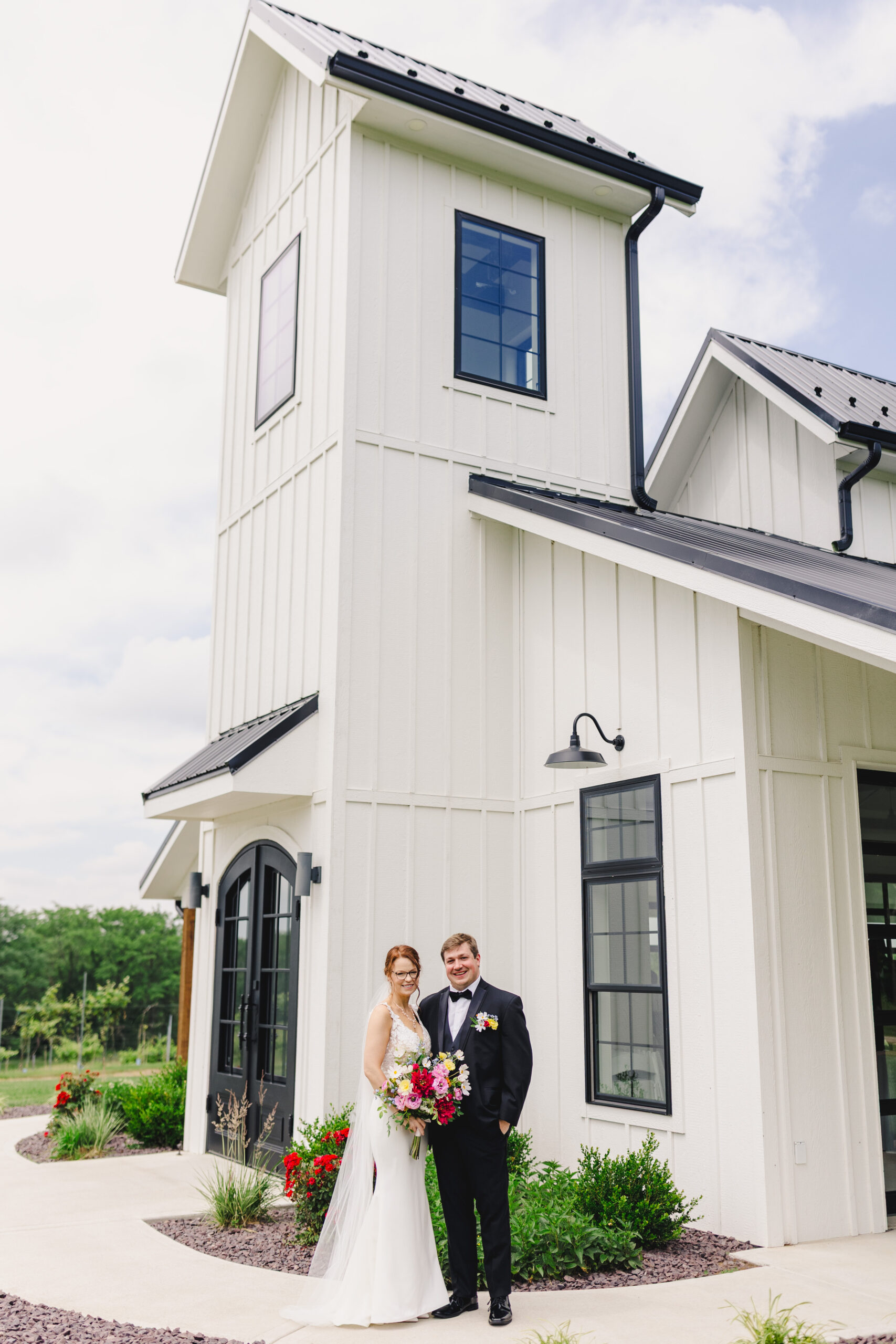 a bride and groom in front of a white building on the day of their wedding