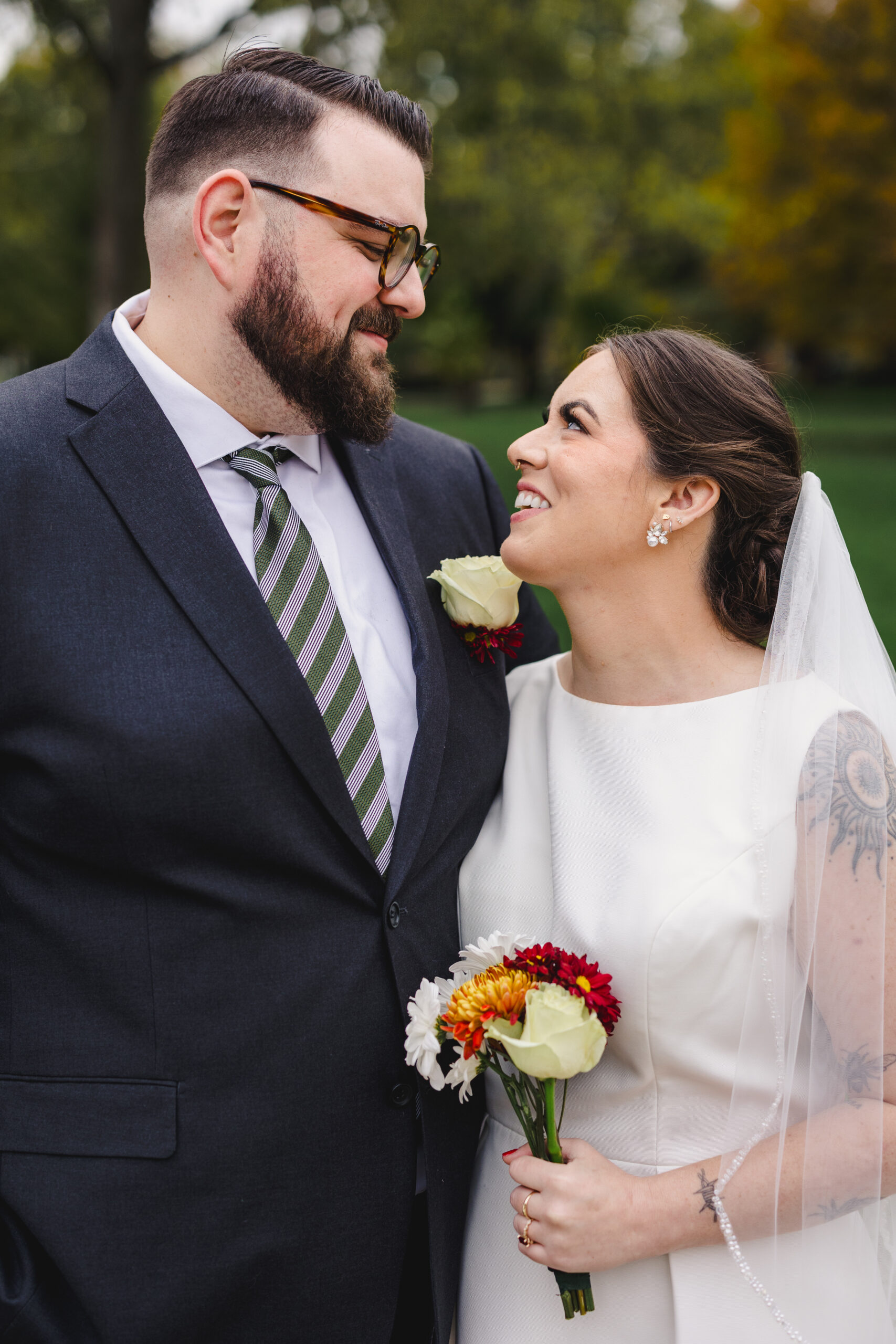 a couple smiling at each other on the day of their wedding 