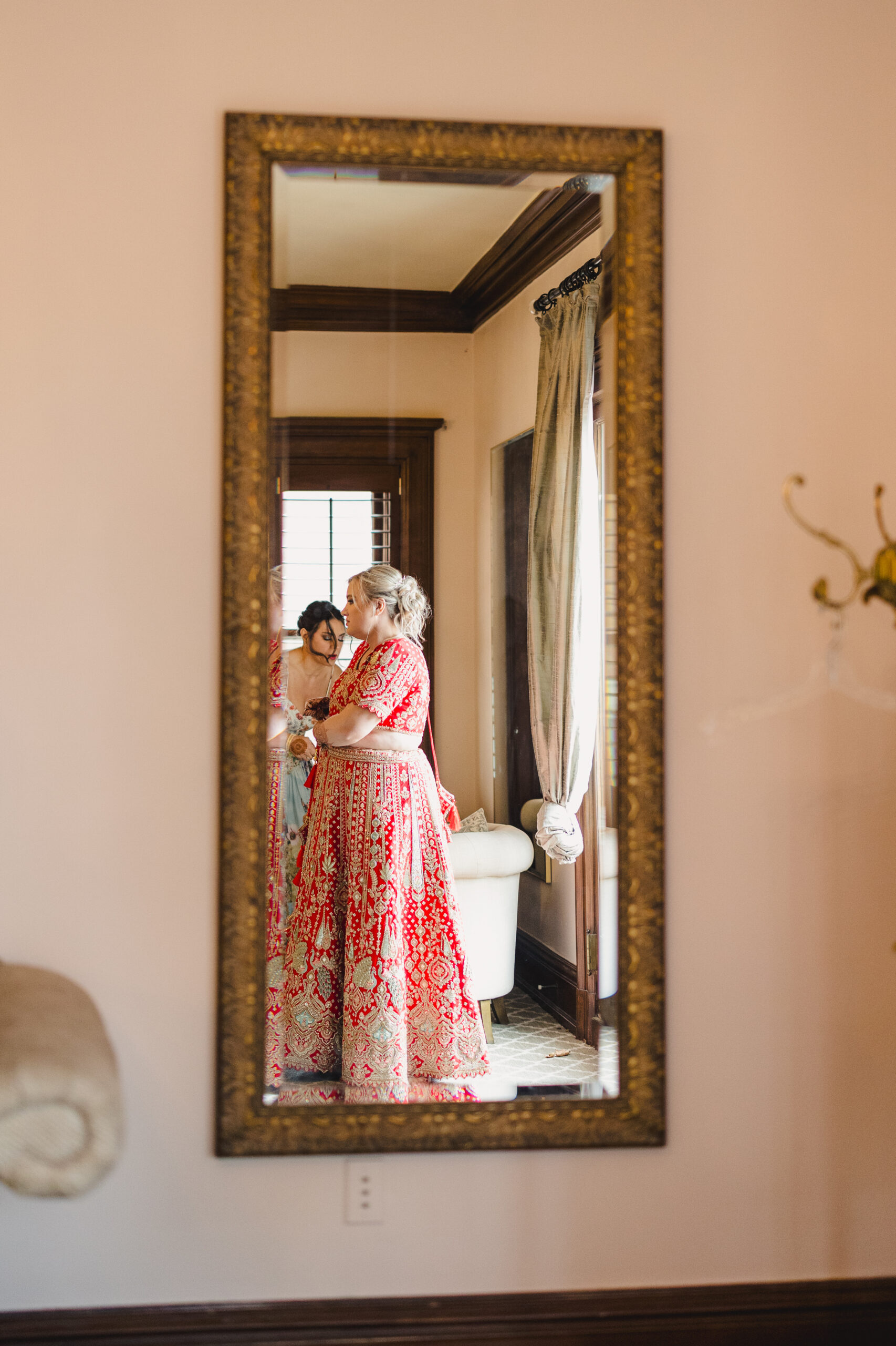 a woman getting ready for her wedding in front of a mirror 