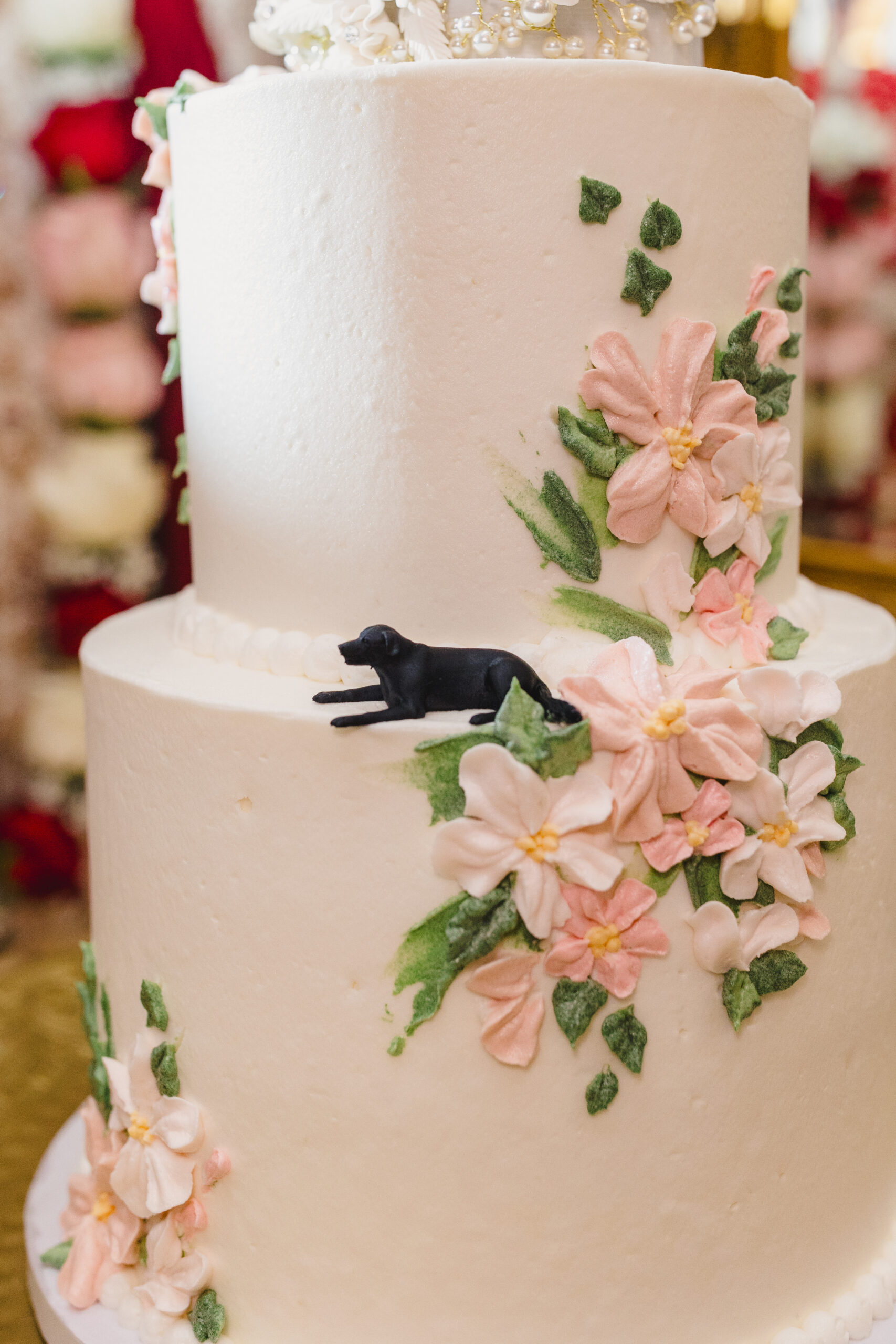 a white wedding cake decorated with pink and white flowers 