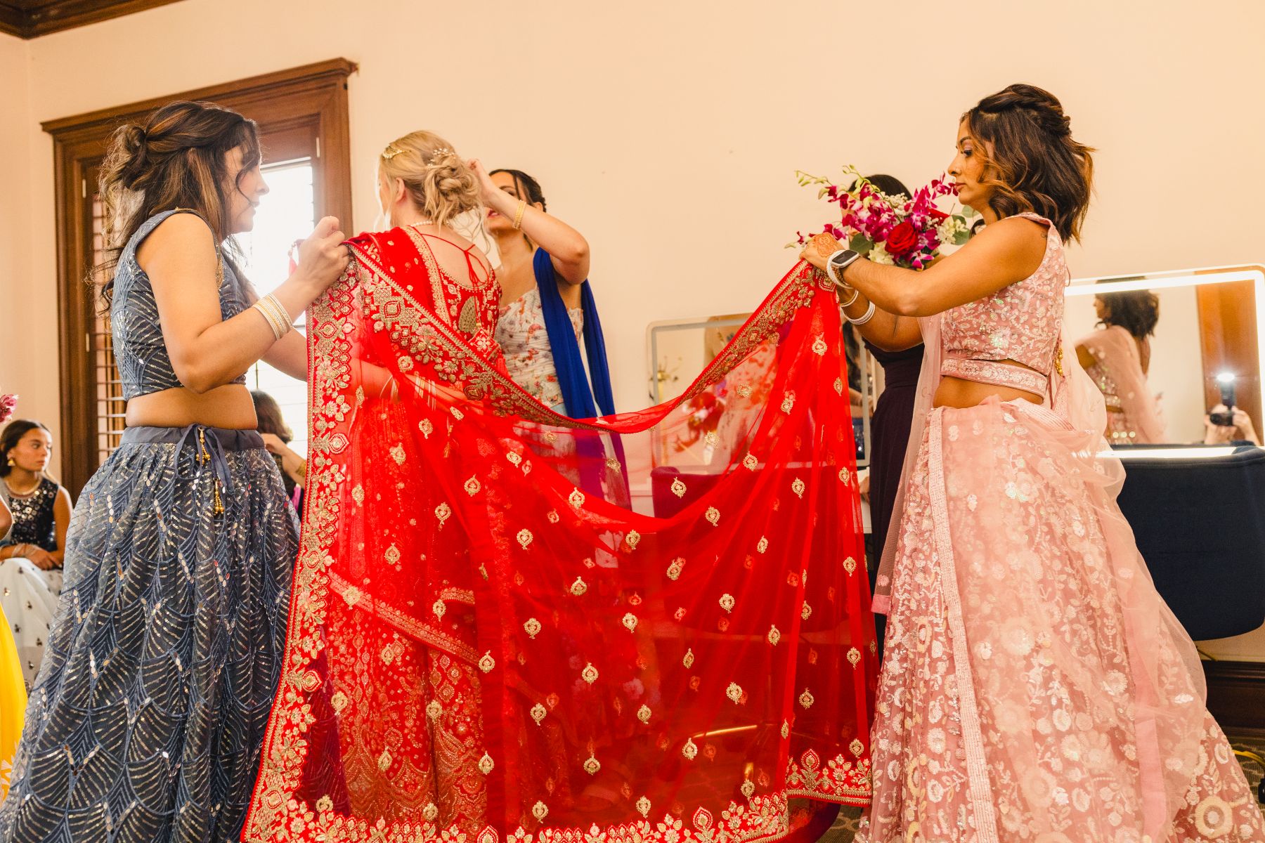 a woman getting ready for her wedding with her bridesmaids 