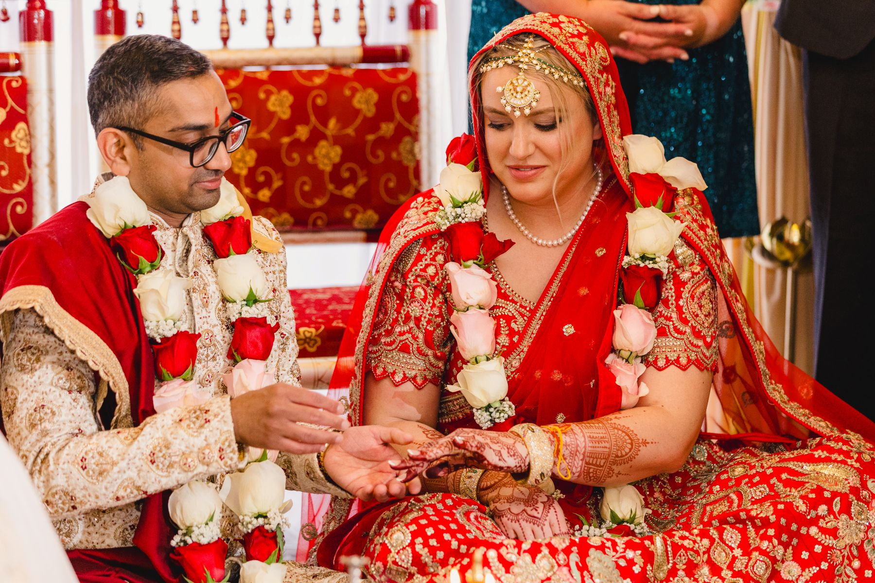 a couple sitting on the ground during their traditional indian wedding ceremony 