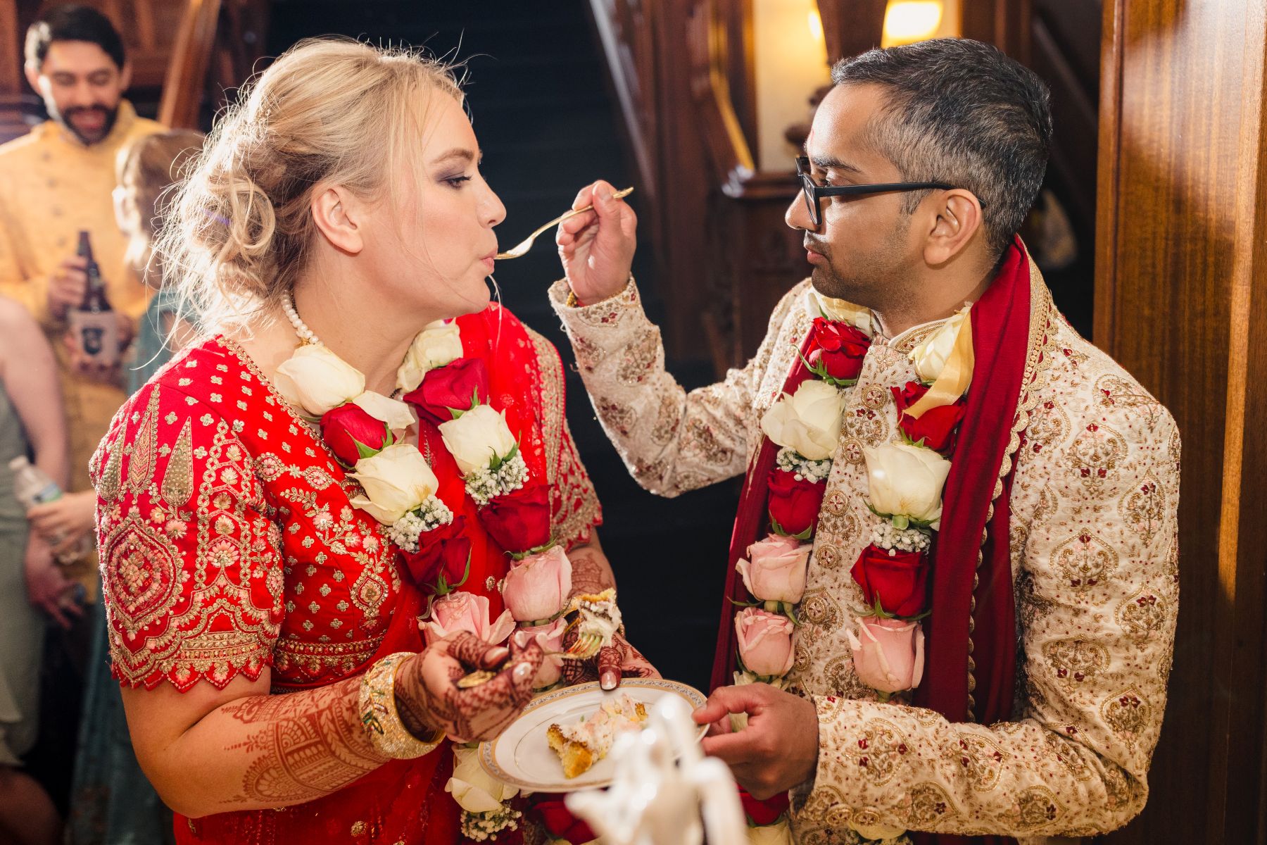 a man feeding his bride wedding cake at their wedding reception 