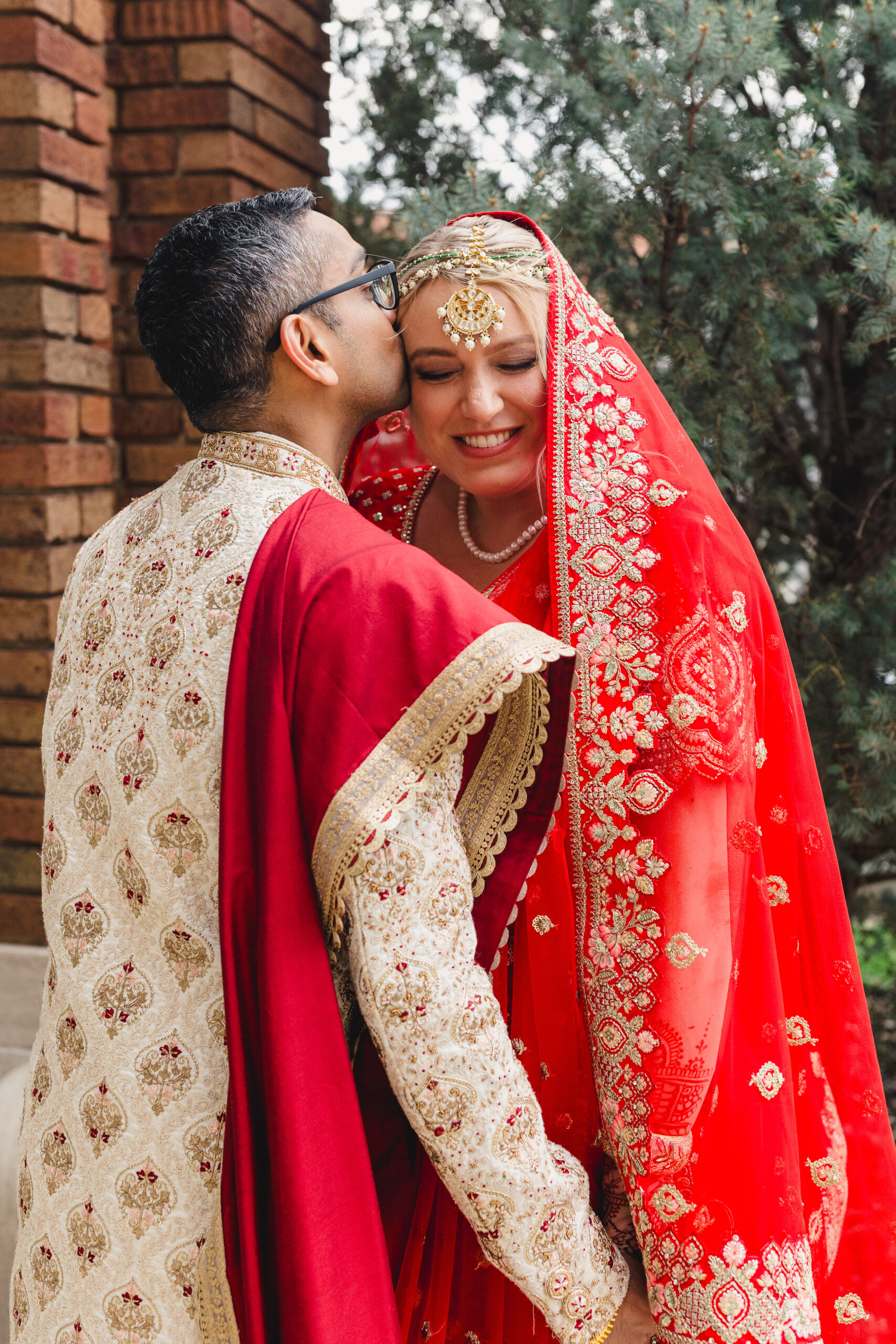 a couple taking wedding portraits outside of loose mansion in kansas city 
