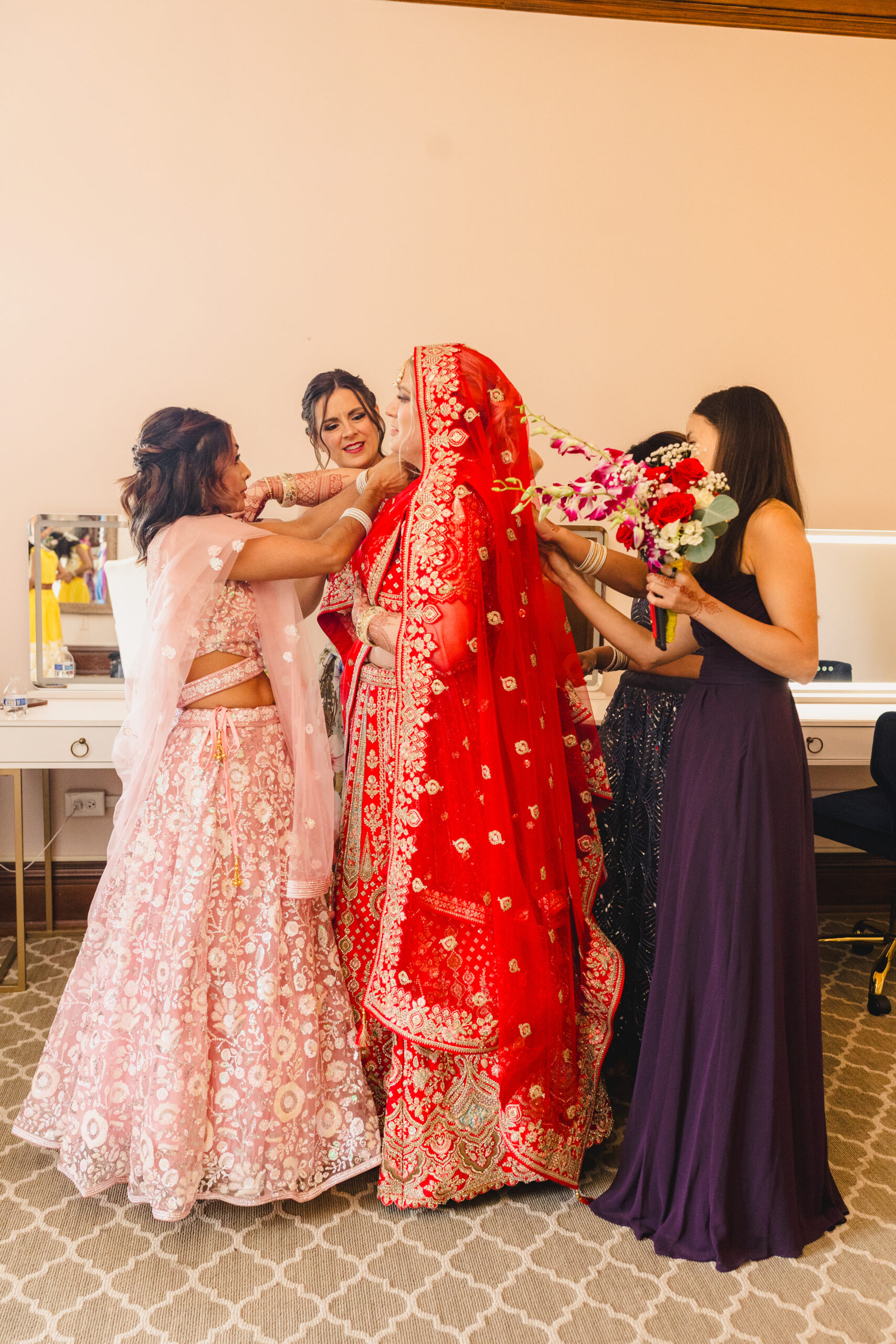 a bride getting ready for ehr wedding with her bridesmaids 