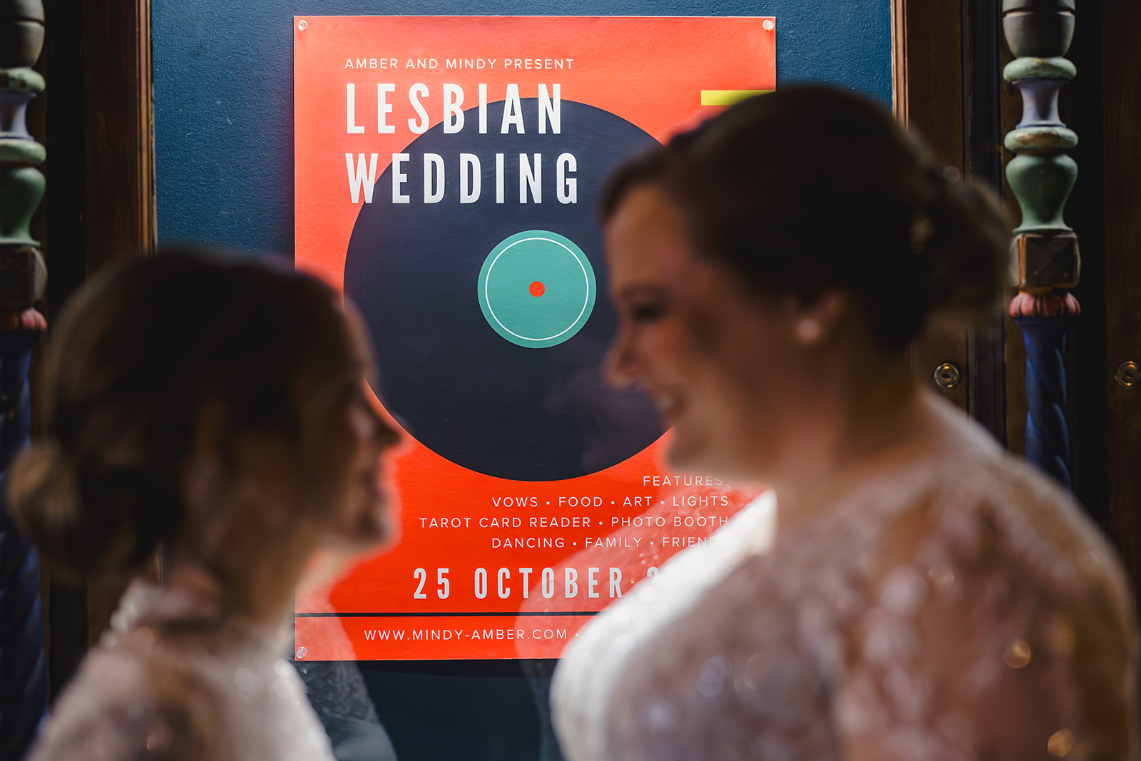 two brides taking bridal wedding photos inside of the uptwon theater 