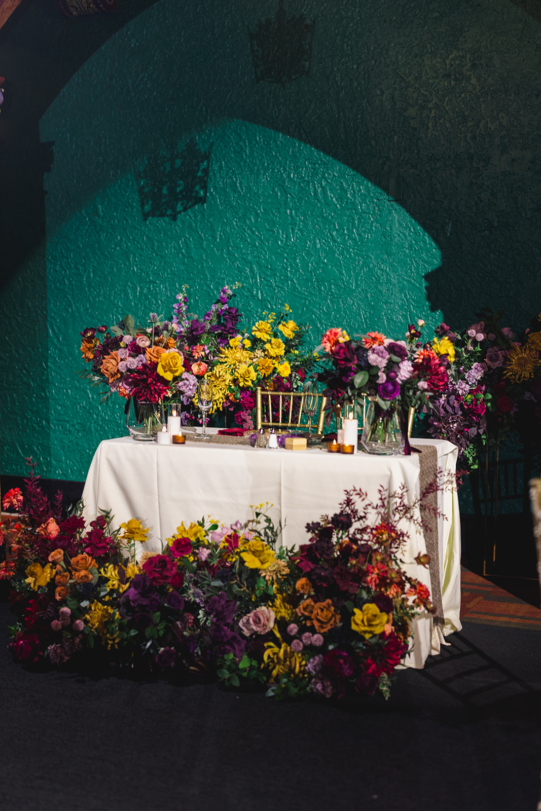 a table set up for two brides inside of the uptown theater in kansas city the table is decorated with flowers and candles 
