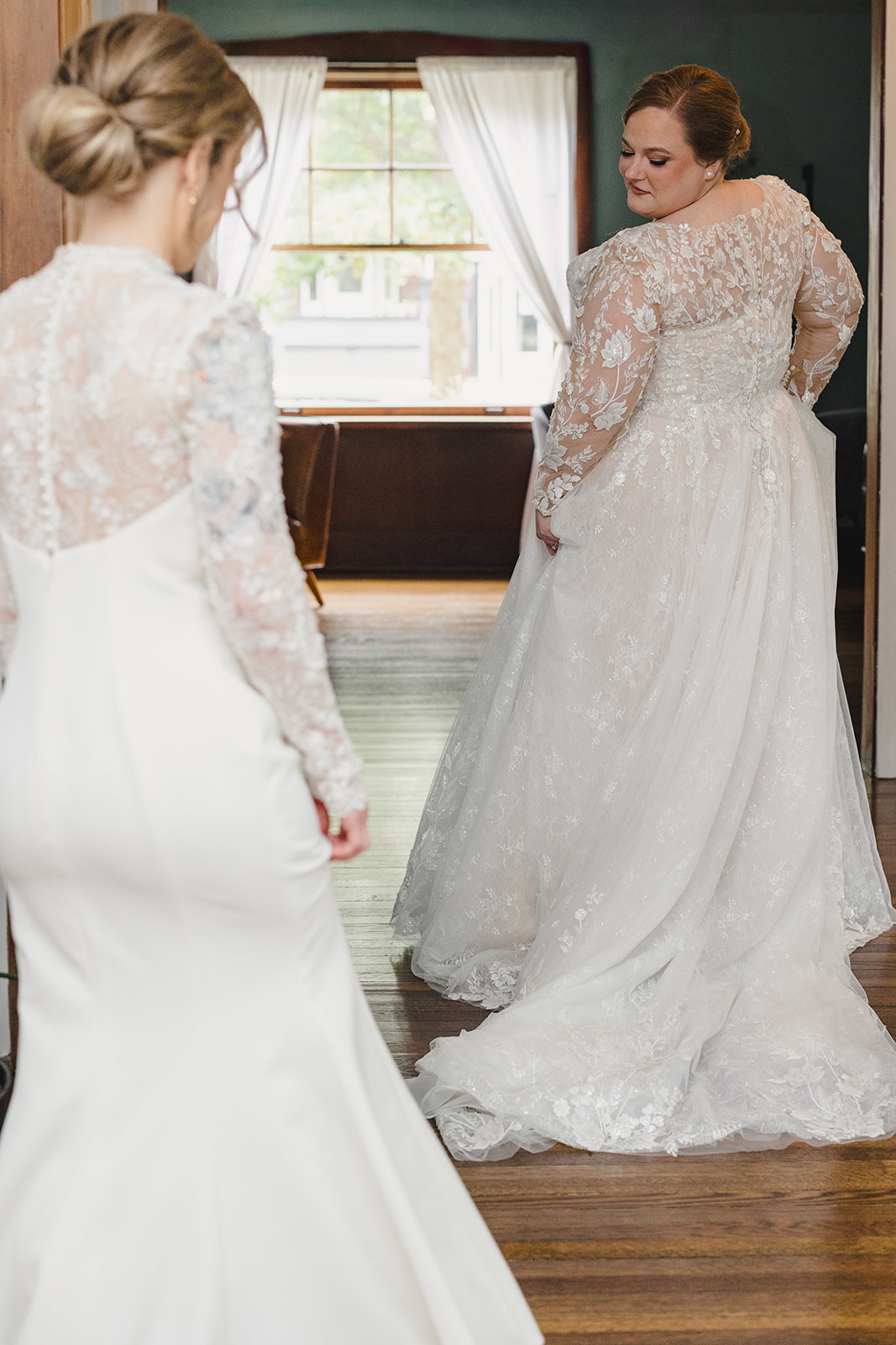 a bride showing off her wedding dress to her partner 