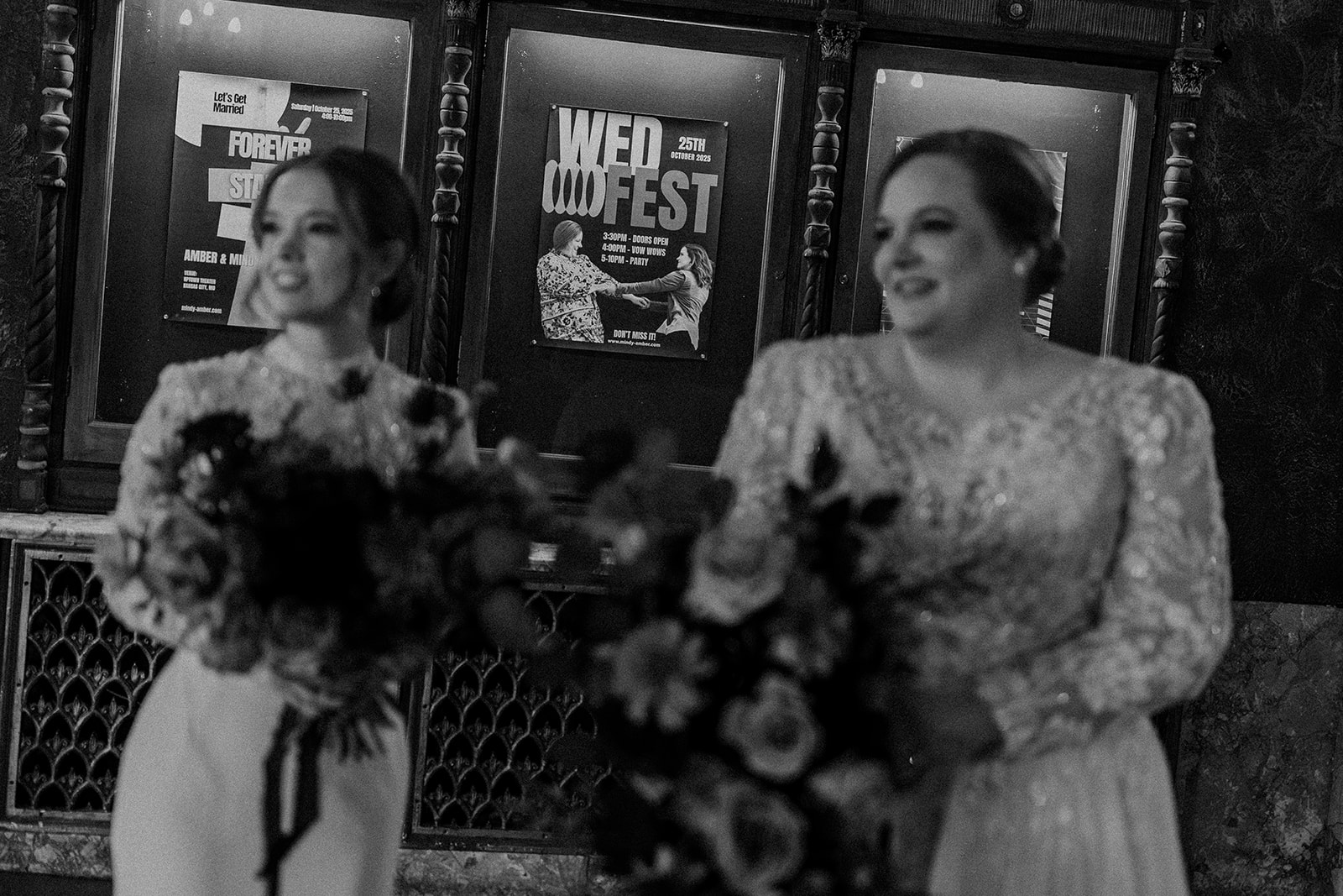 two brides taking bridal portraits together inside the uptown theater in kansas city 