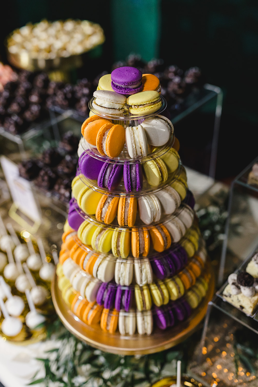 a table with various desserts including a macaroon display for a wedding 
