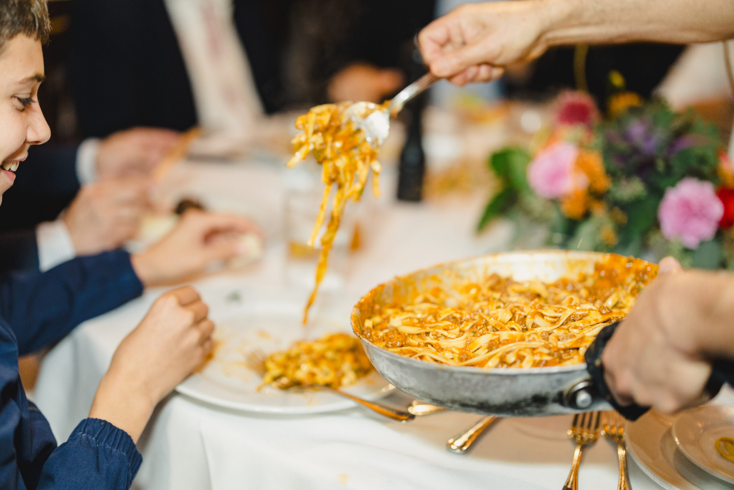 pasta being served at a rehearsal dinner at lidia's in kansas city 