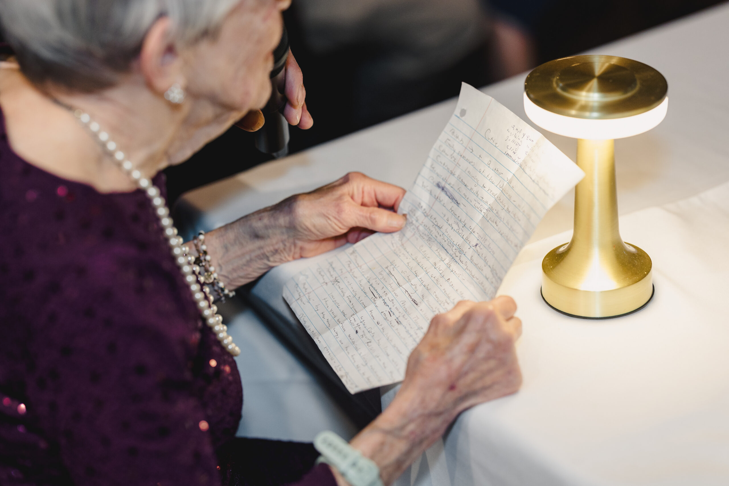 a woman reading a speech at a rehearsal dinner 