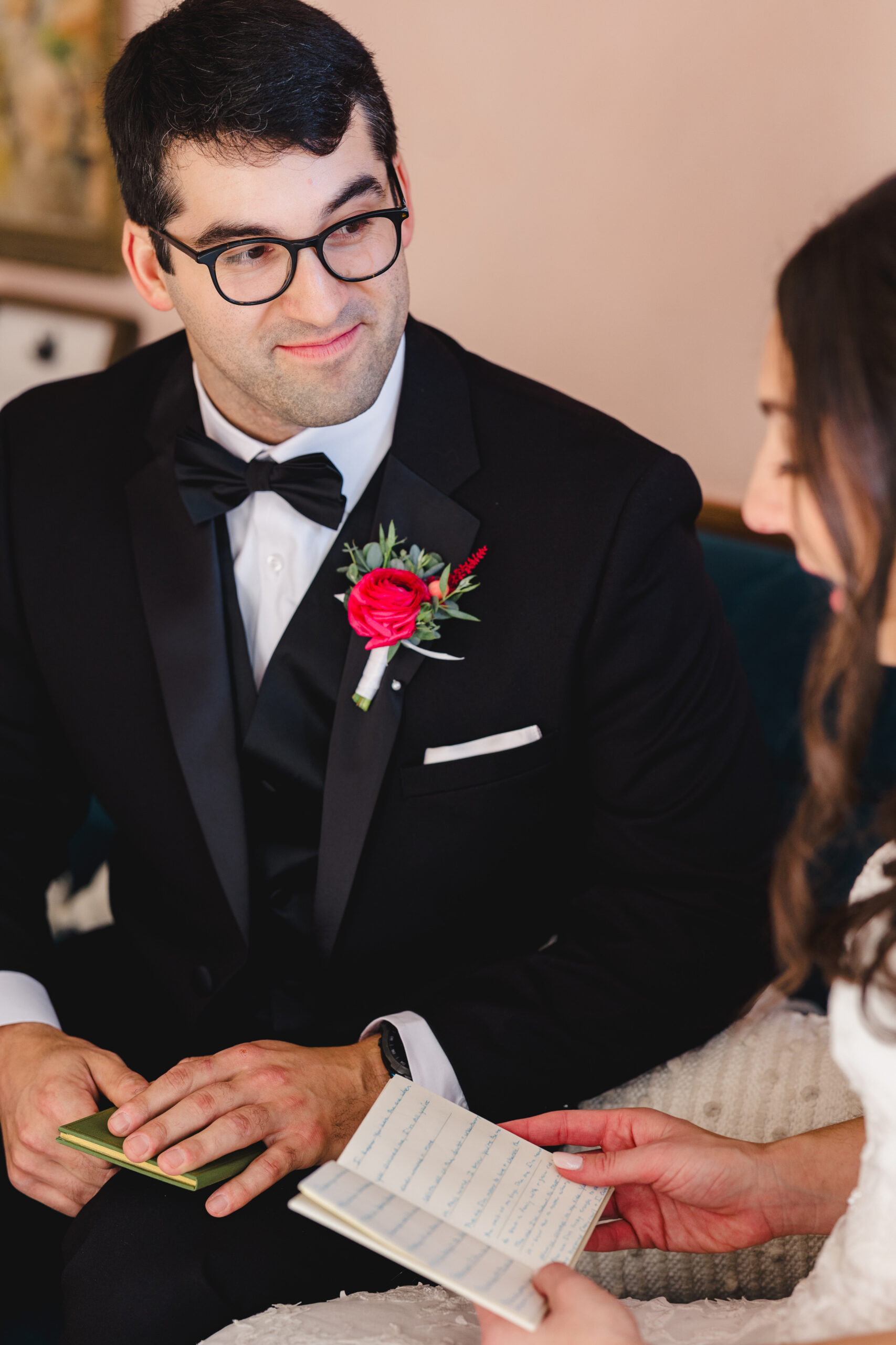 a couple reading private vows to each other before their wedding ceremony