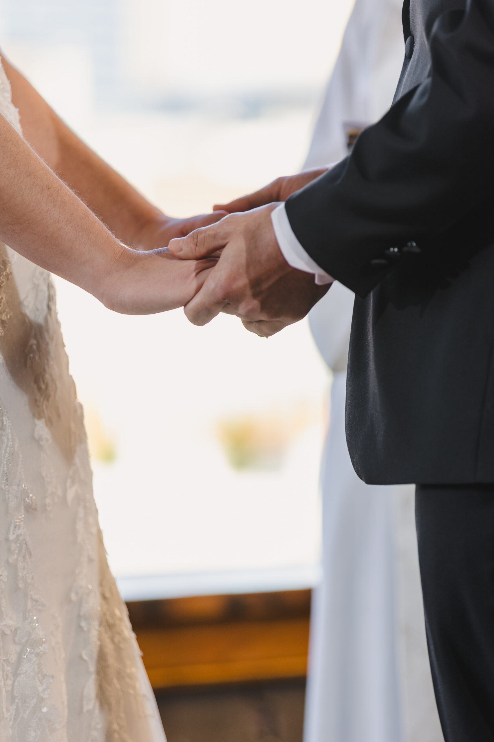 a bride and groom holding hands at their wedding ceremony