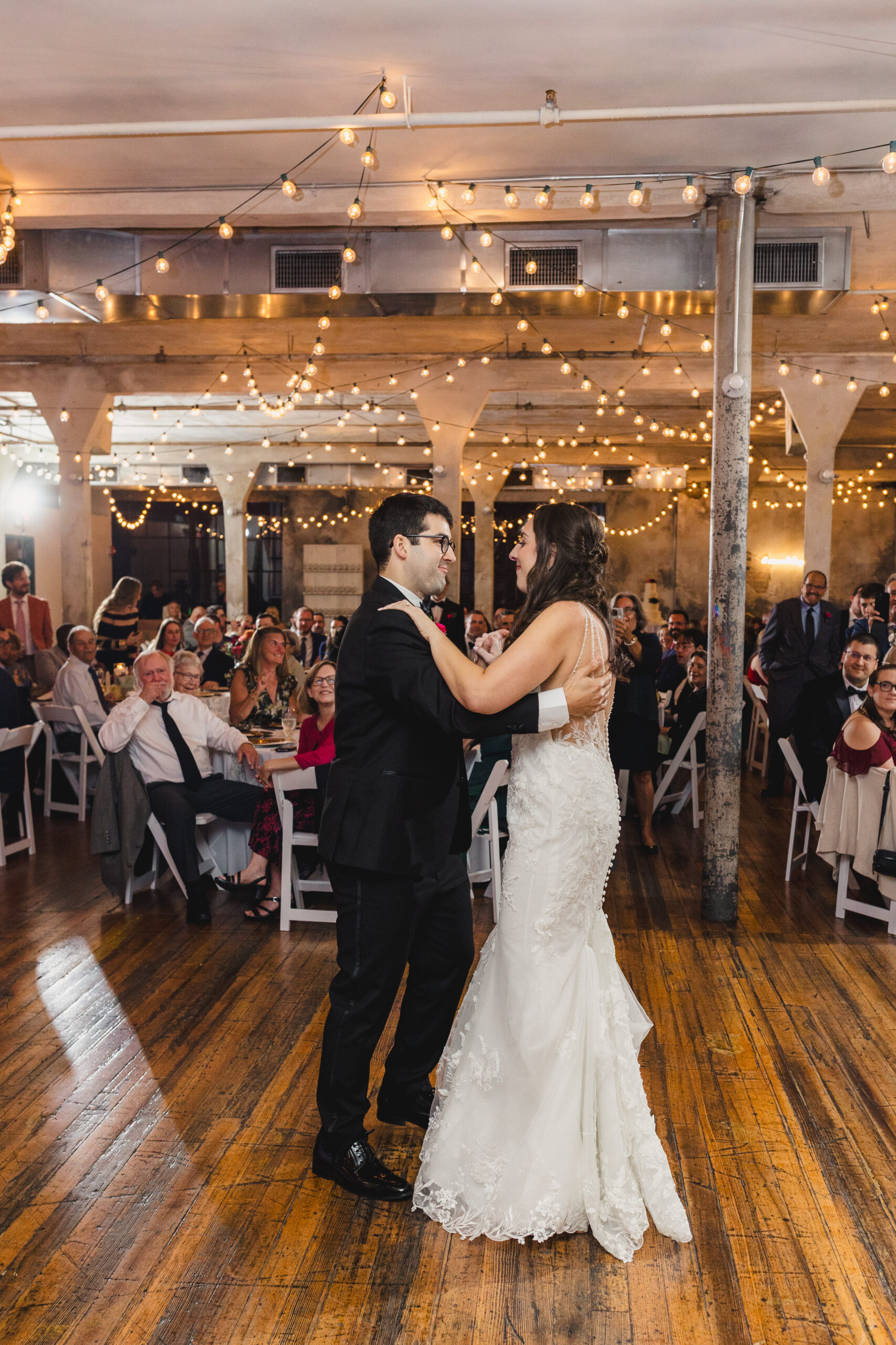 a couple sharing their first dance at their wedding reception inside the bauer in kansas city 