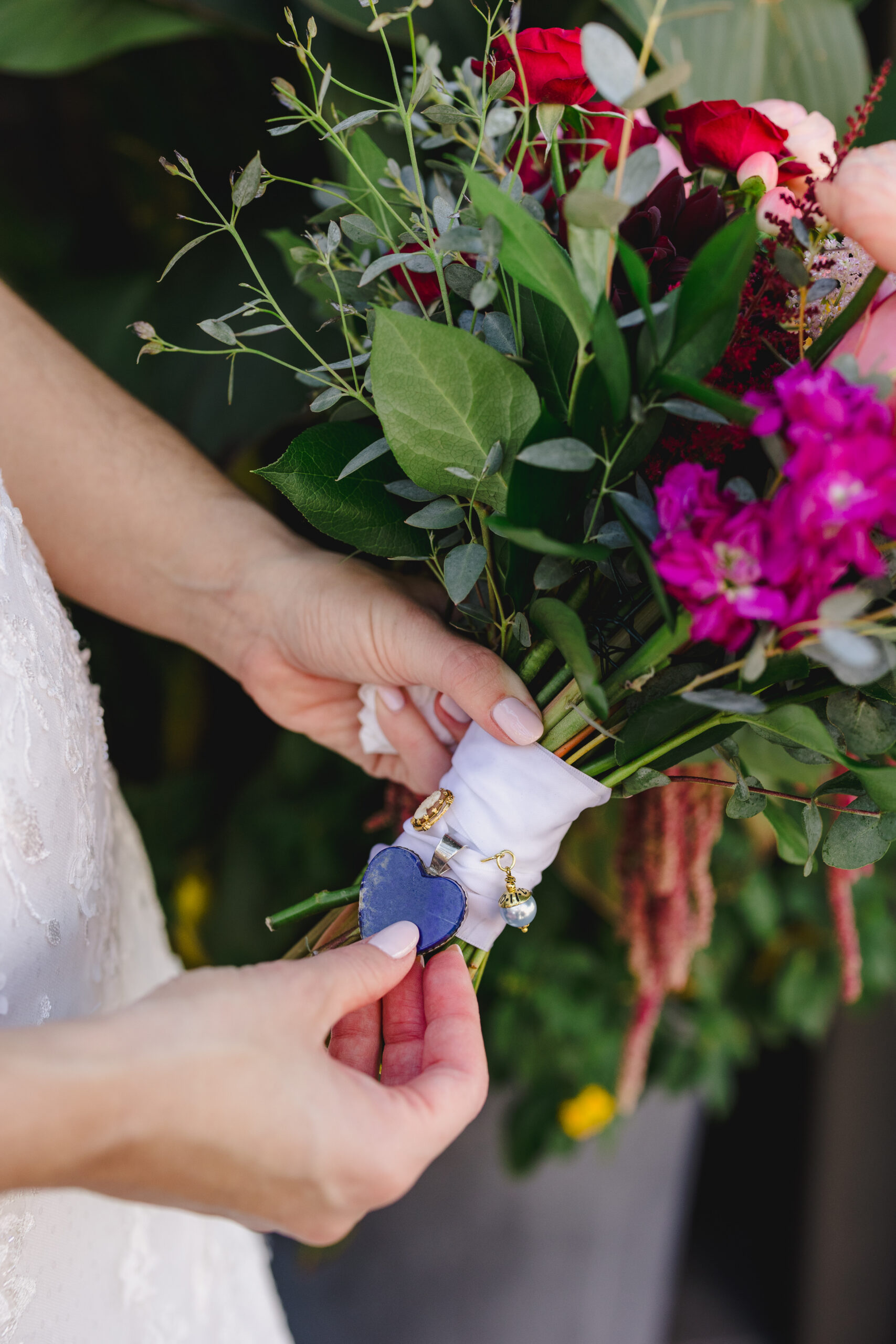 a bride holding a colorful bouquet of flowers 