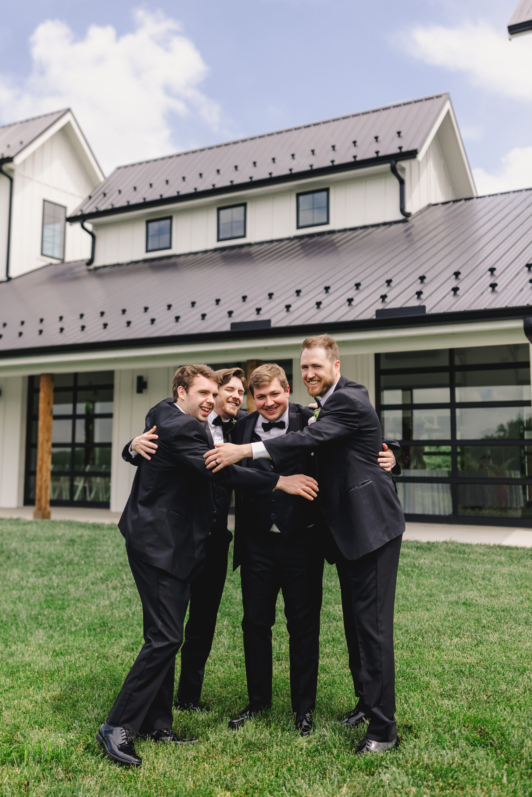 a groom taking a photo with his wedding party