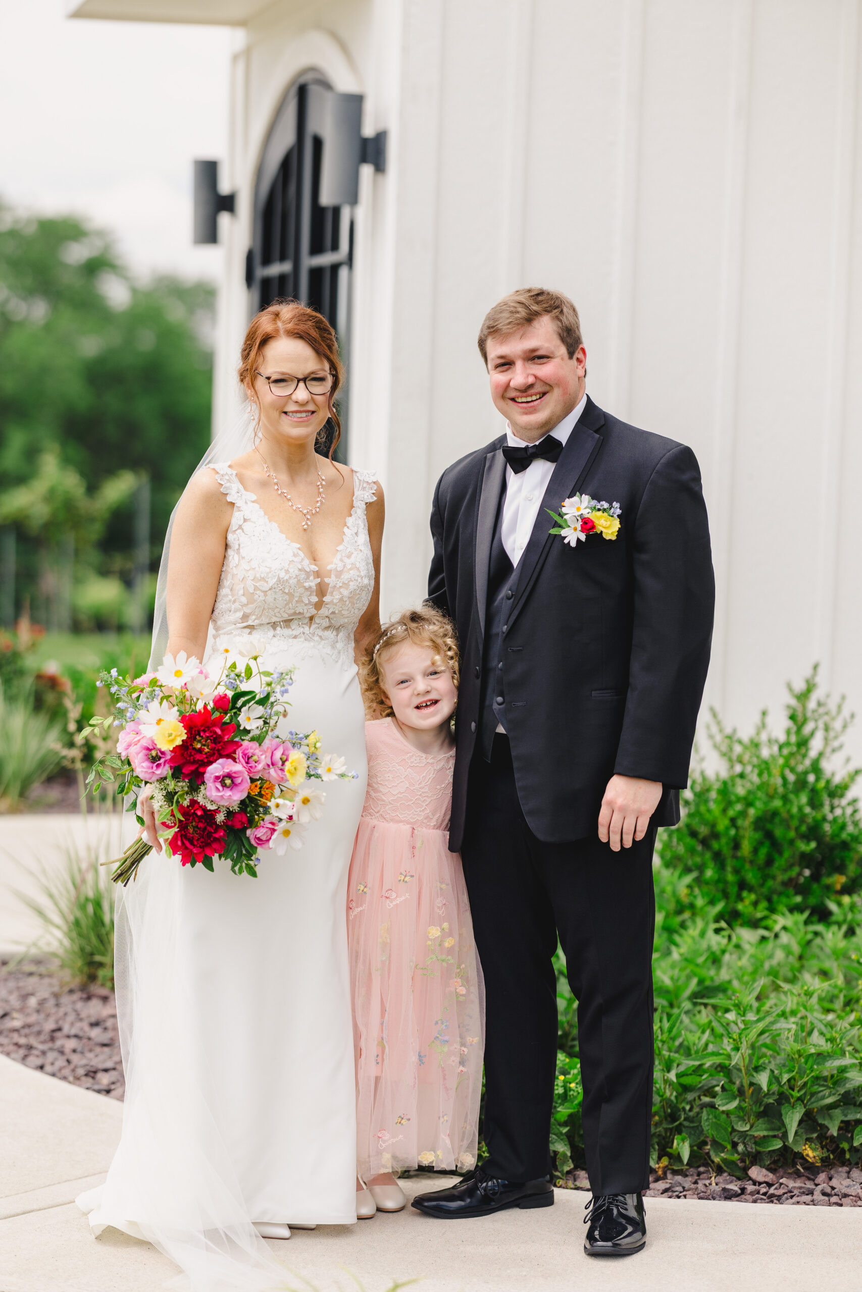 a bride, groom, and their daughter