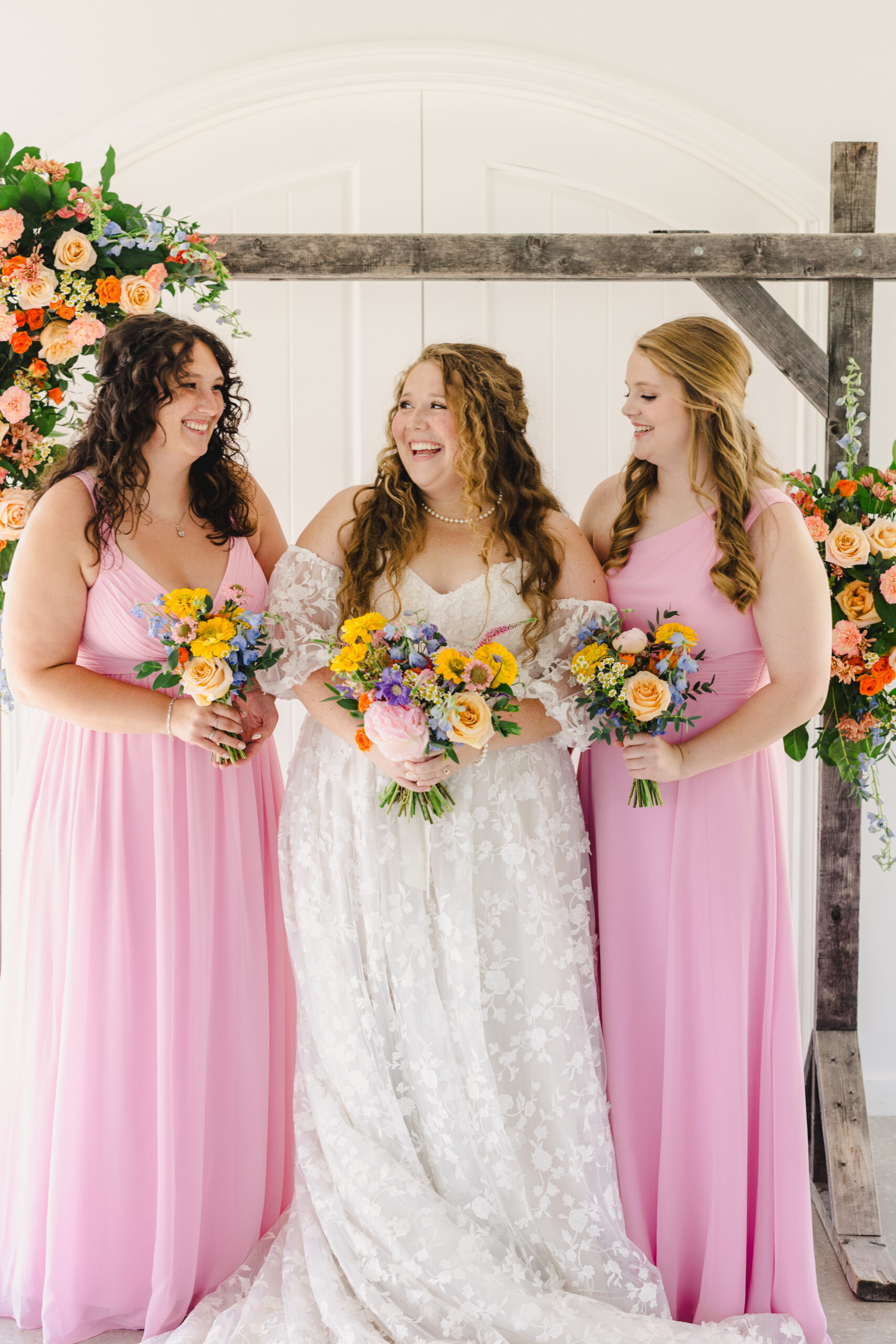 a bride taking a photo with her bridesmaids