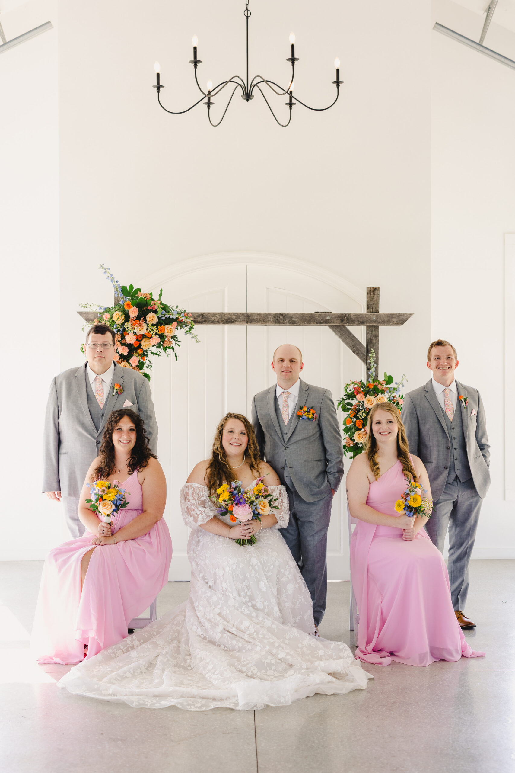 a bride and groom taking a photo with their wedding aprty