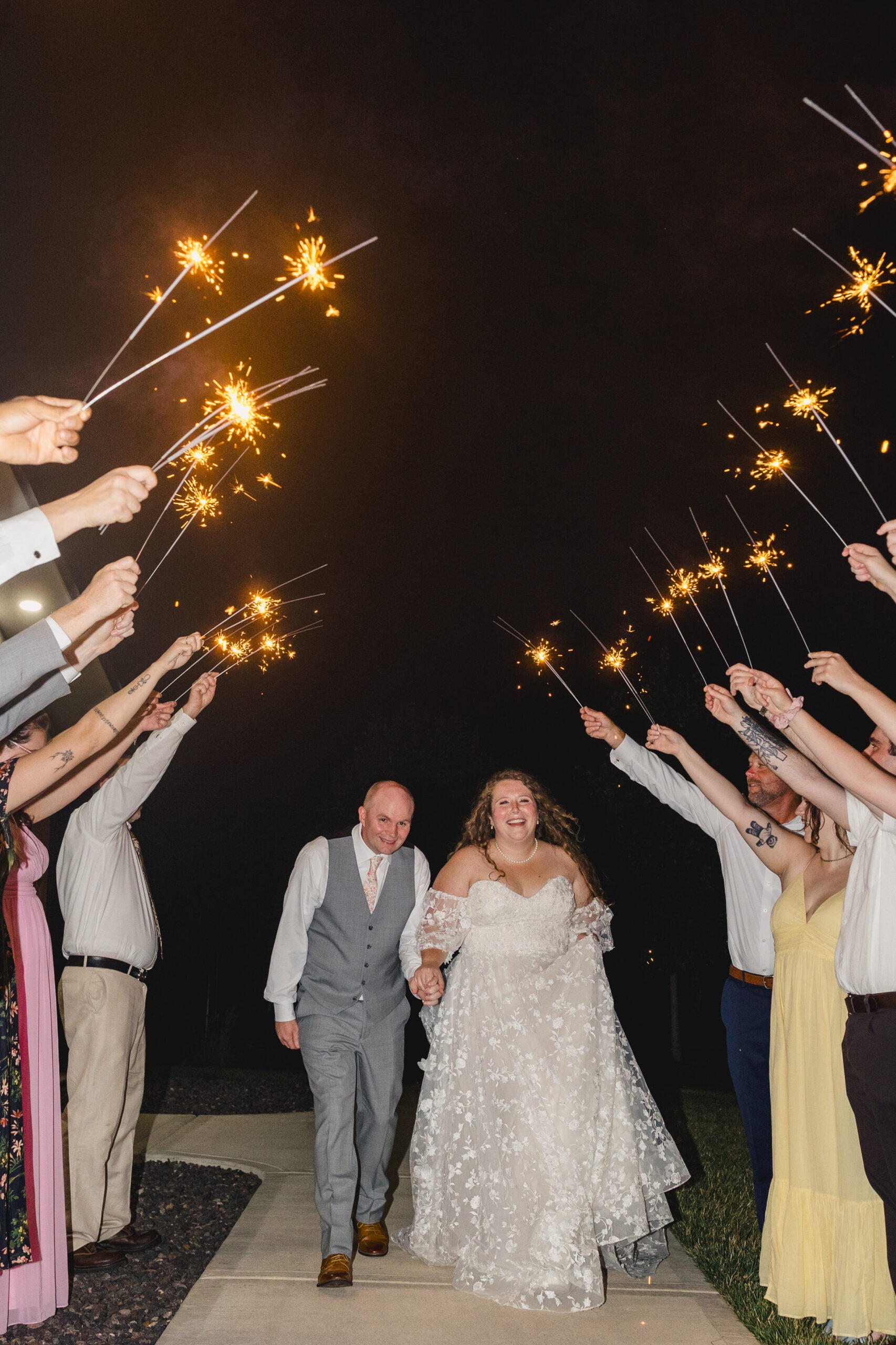 a bride and groom having a sparkler exit 