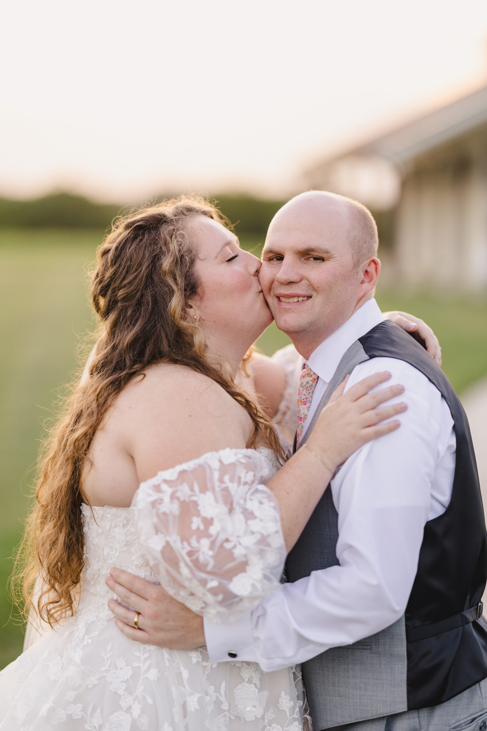 a bride kissing her husband on the cheek