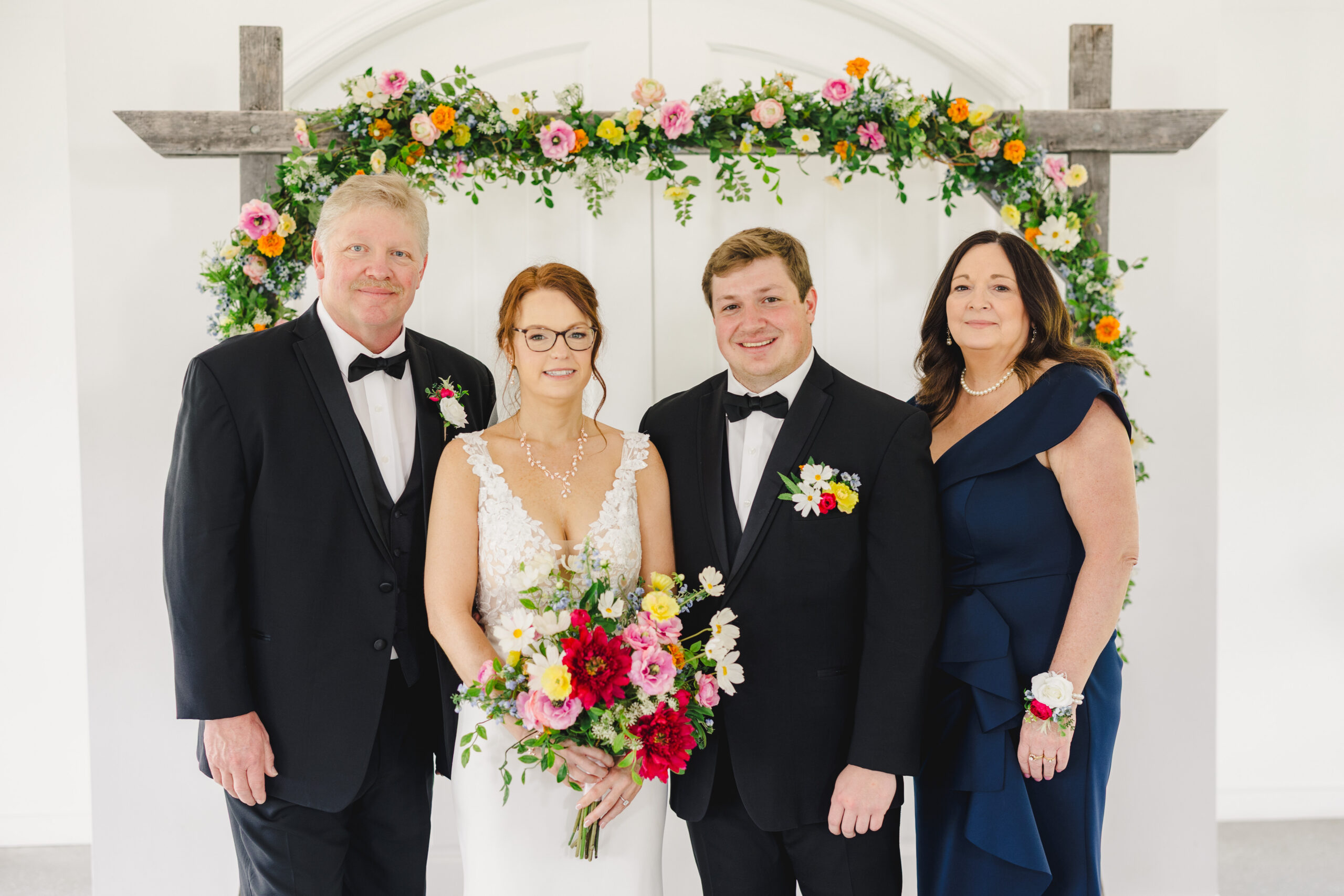 a bride and groom taking family wedding photos inside the brim in kansas city