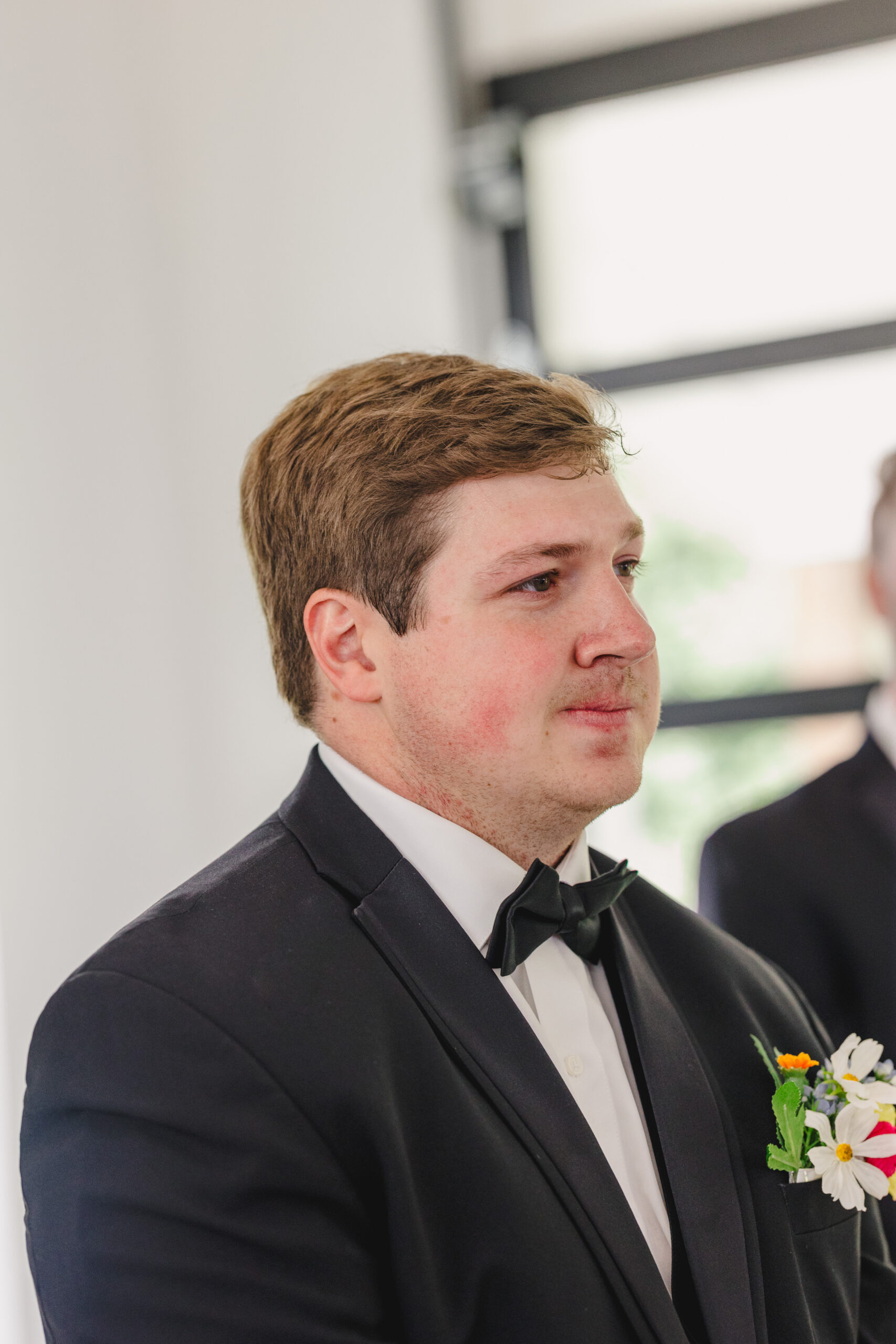 a groom getting teary eyed at his wedding