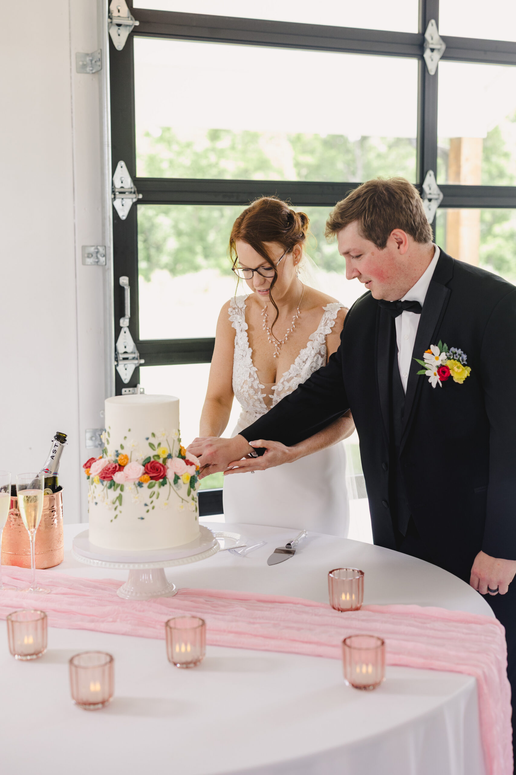 a bride and groom cutting their wedding cake at their wedding reception 