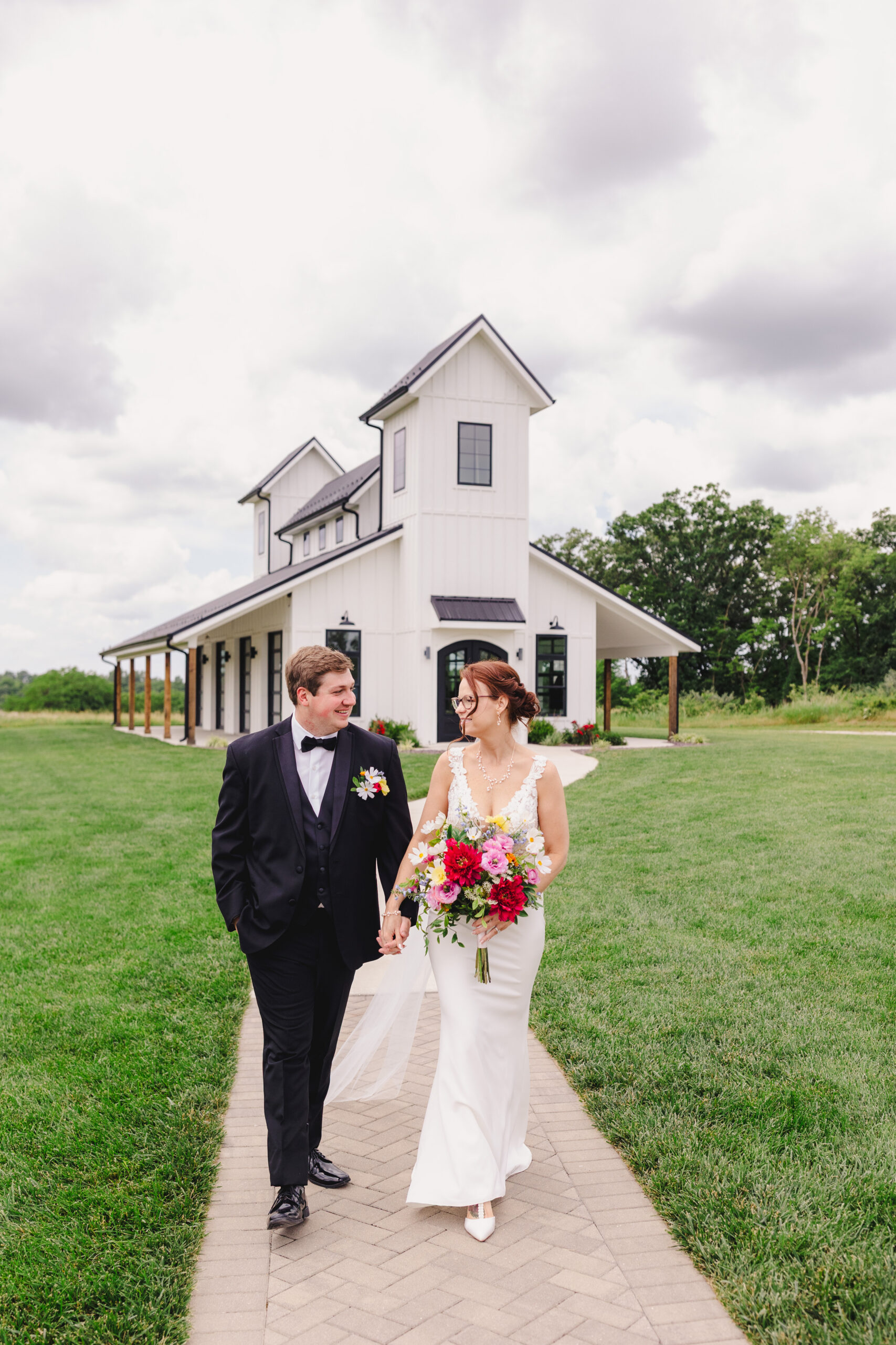 a bride and groom taking wedding portraits in front of the brim in kansas city