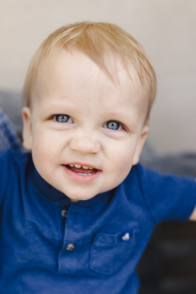 A close up portrait of a toddler smiling 