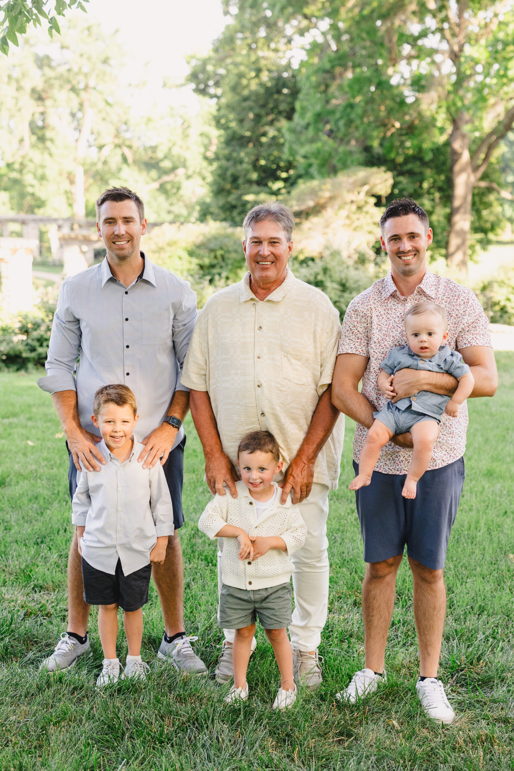 three fathers with their songs taking a family photo 