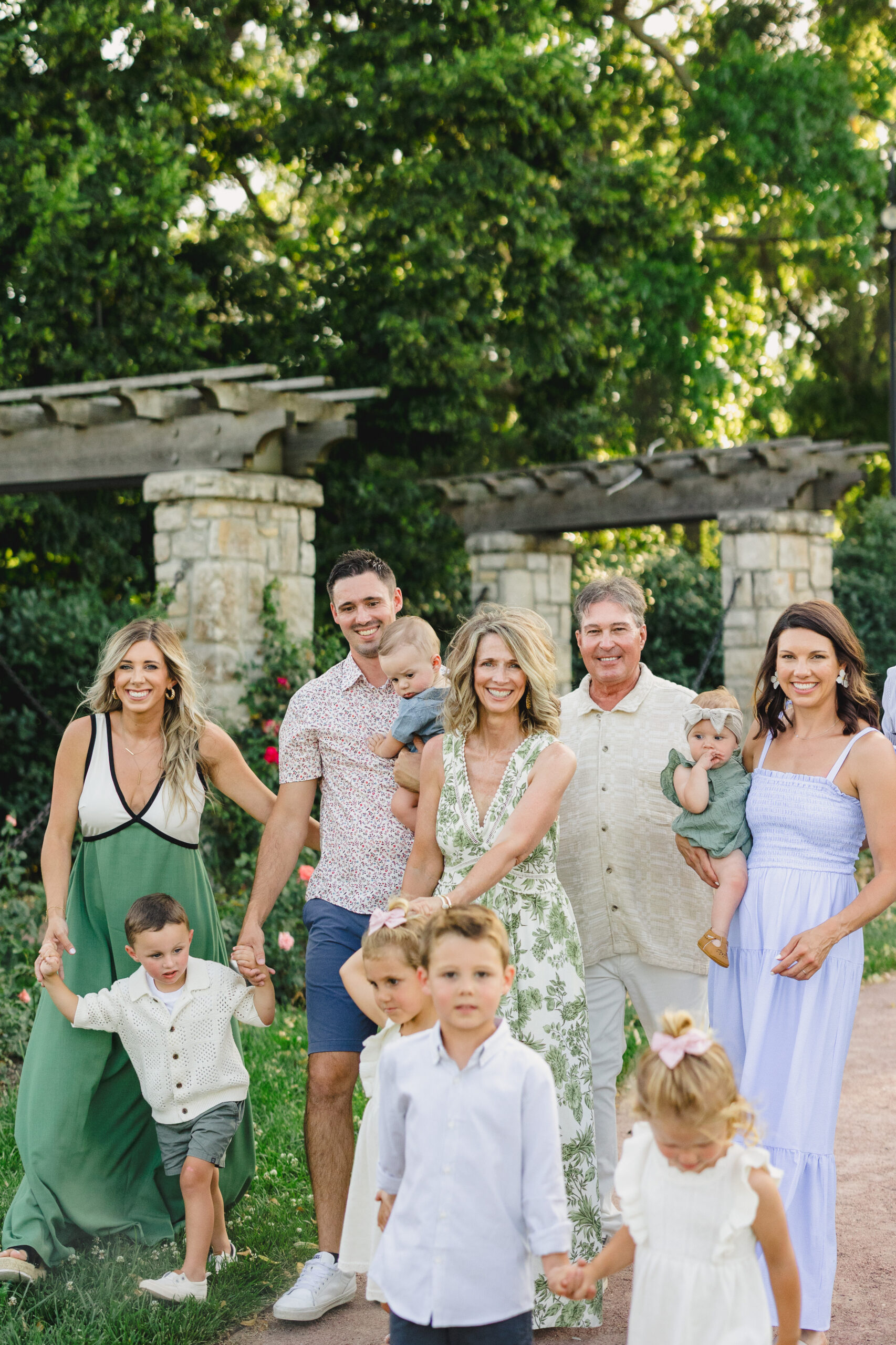 a family taking summer family photos in loose park in kansas city 