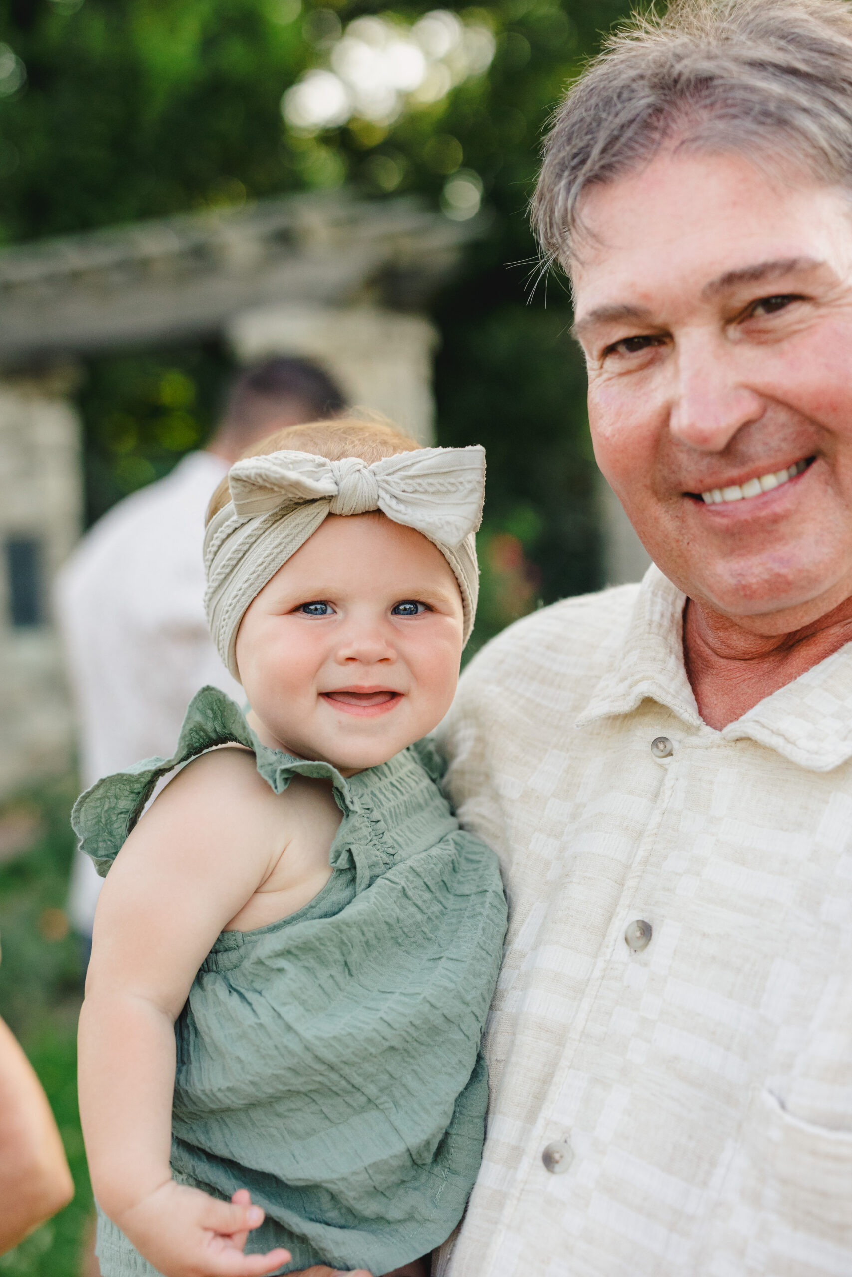 a grandfather holding his grand daughter 