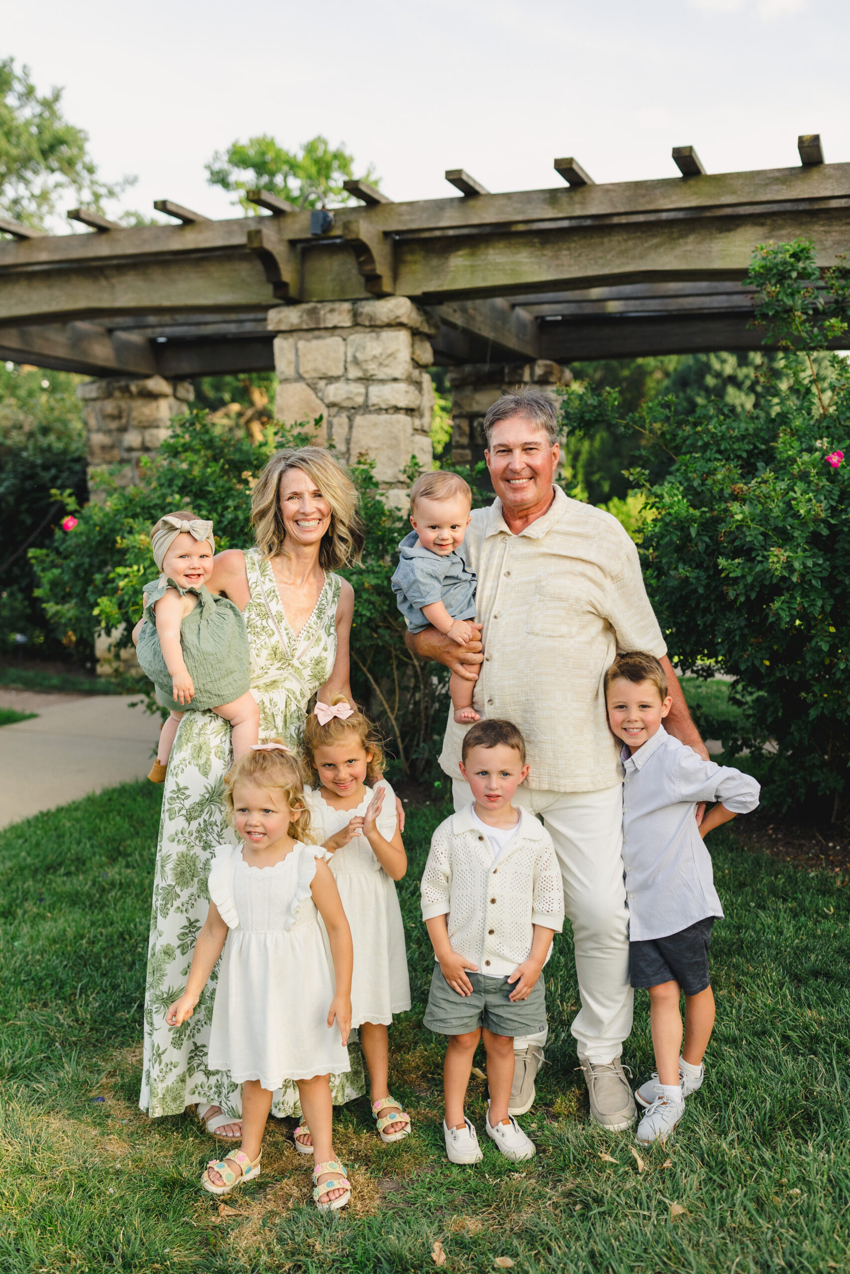 Two grandparents taking a family photo with their grandchildren 
