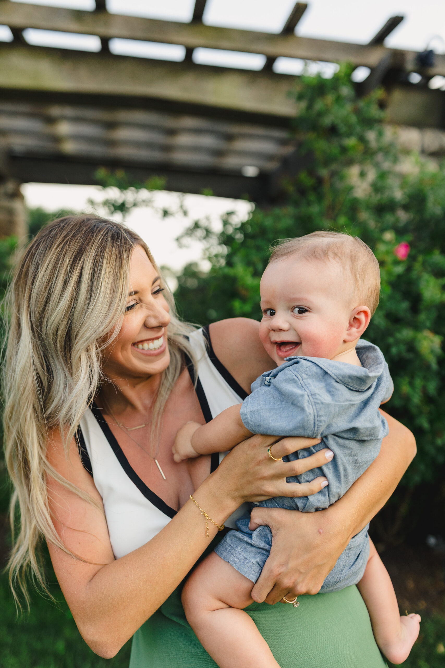 a mother taking a photo with her baby boy