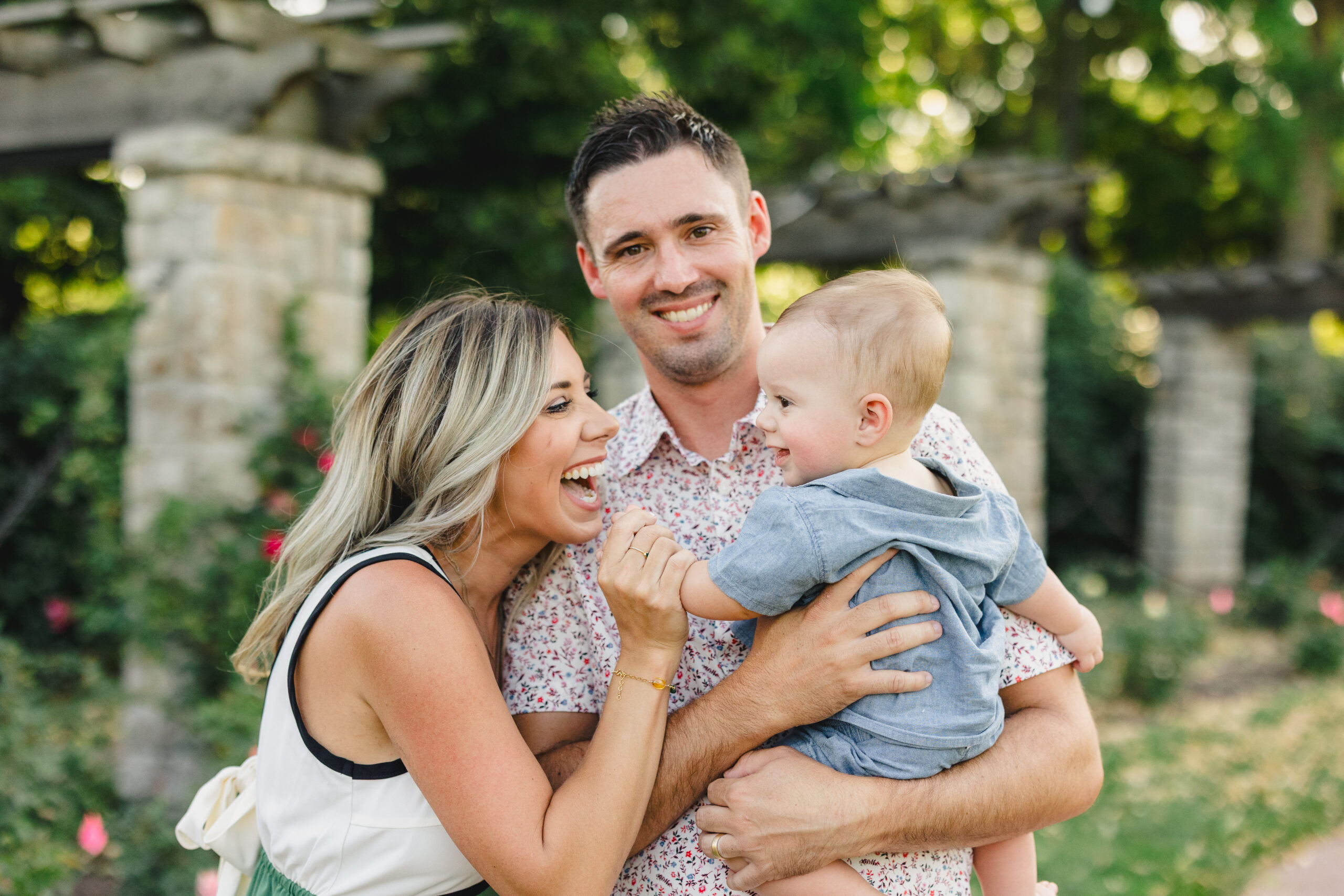 a mother and father holding their baby boy 