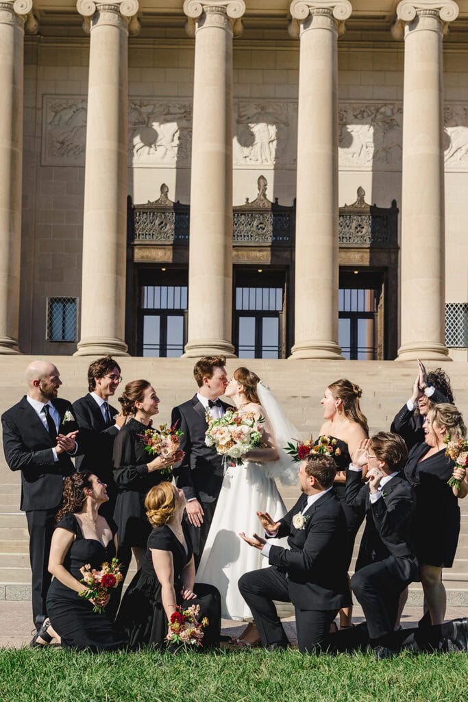 A wedding party featuring all black attire at the Nelson Atkins Museum