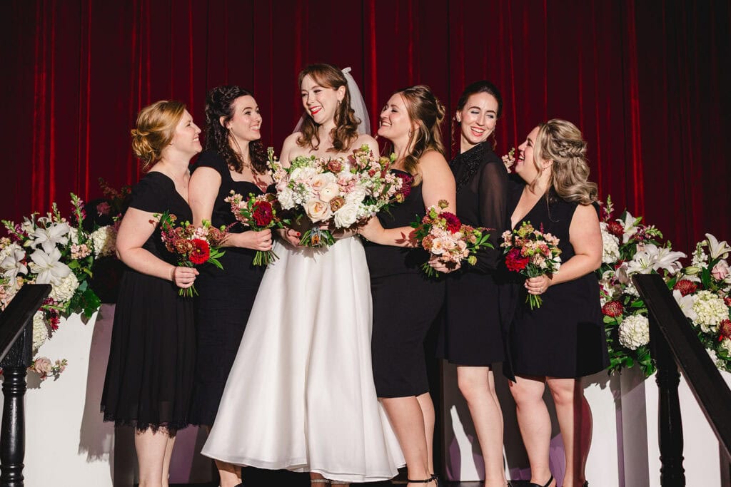 Bridesmaid shots featuring all black dresses at the Madrid Theatre in Kansas City