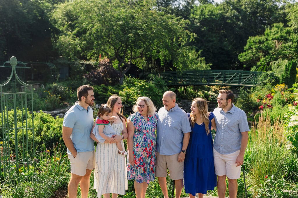 Overland Park Arboretum Family Photos with the Claude Mone Bridge behind them.
