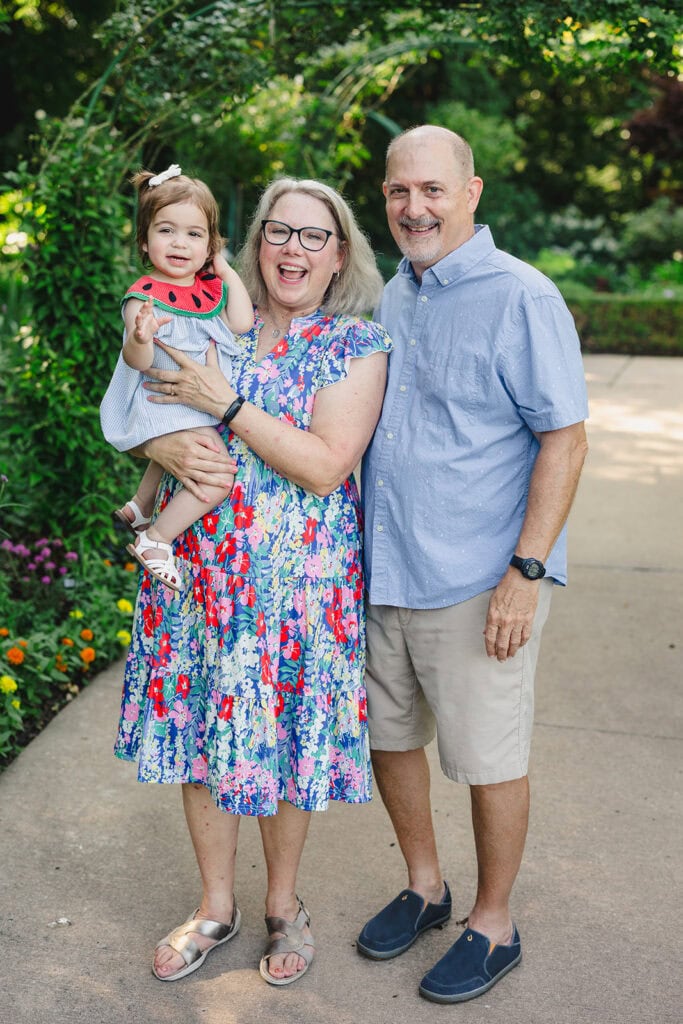 Grandparents with their grandchild at the Overland Park Arboretum